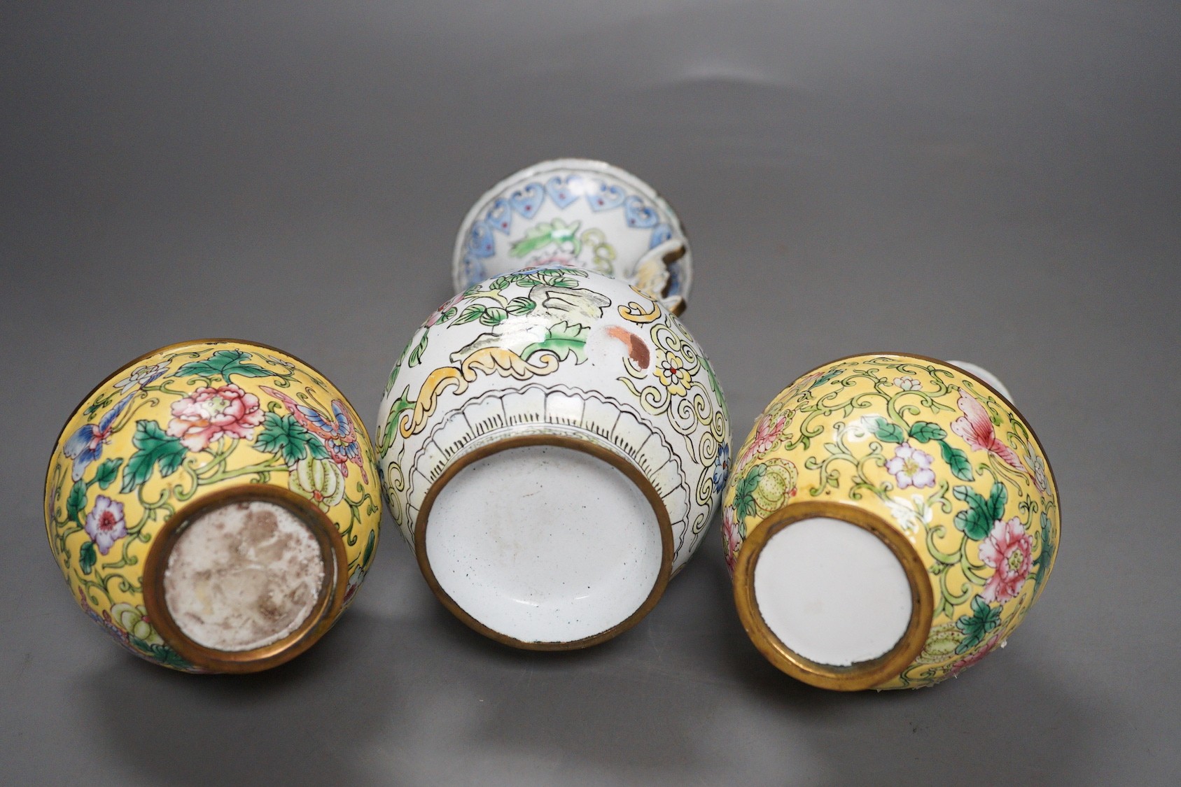 A pair of Chinese Guangzhou yellow enamel vases and another similar vase, tallest 15cms high.